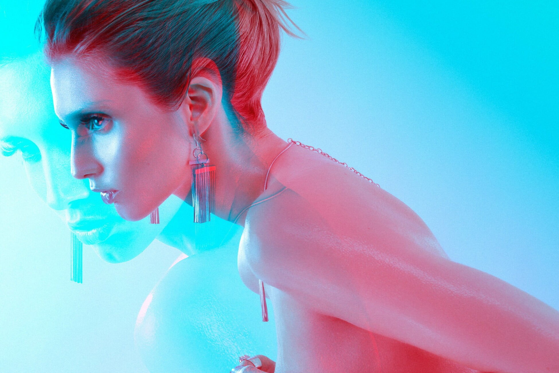 Dynamic composition featuring model Adeline Petit's nudity and exquisite jewelry, captured in an artistic electric blue and red image by photographer Etienne Delorme for Faust Magazine.